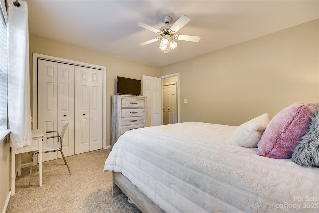 339 Gold Hill Road Fort Mill, SC 29715 - Photo 20 of 48 a bedroom with a large bed and a chandelier