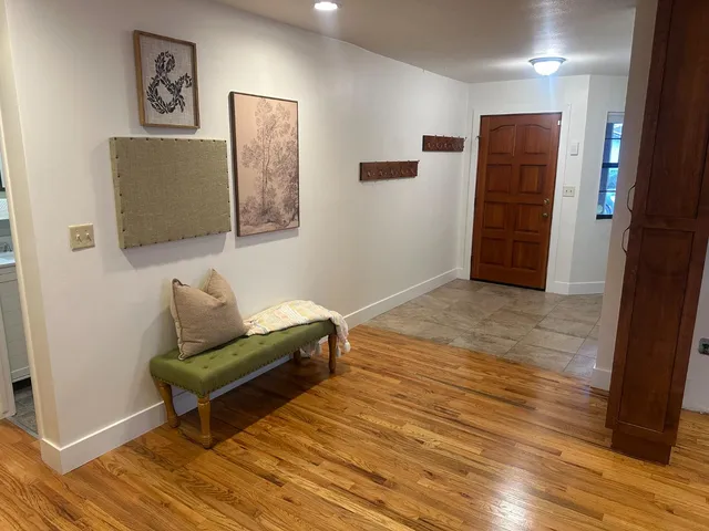 a kitchen with granite countertop a stove a sink dishwasher and cabinets with wooden floor