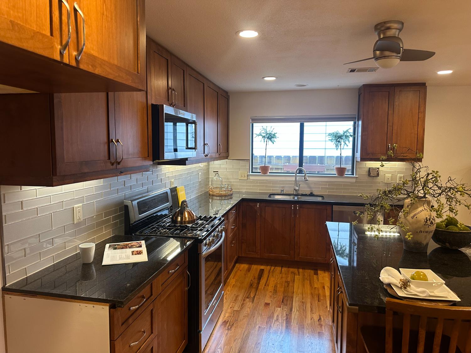 2013 Jerry Lane Lodi, CA 95242 - Photo 14 of 52 a kitchen with granite countertop a stove a sink a refrigerator and wooden cabinets