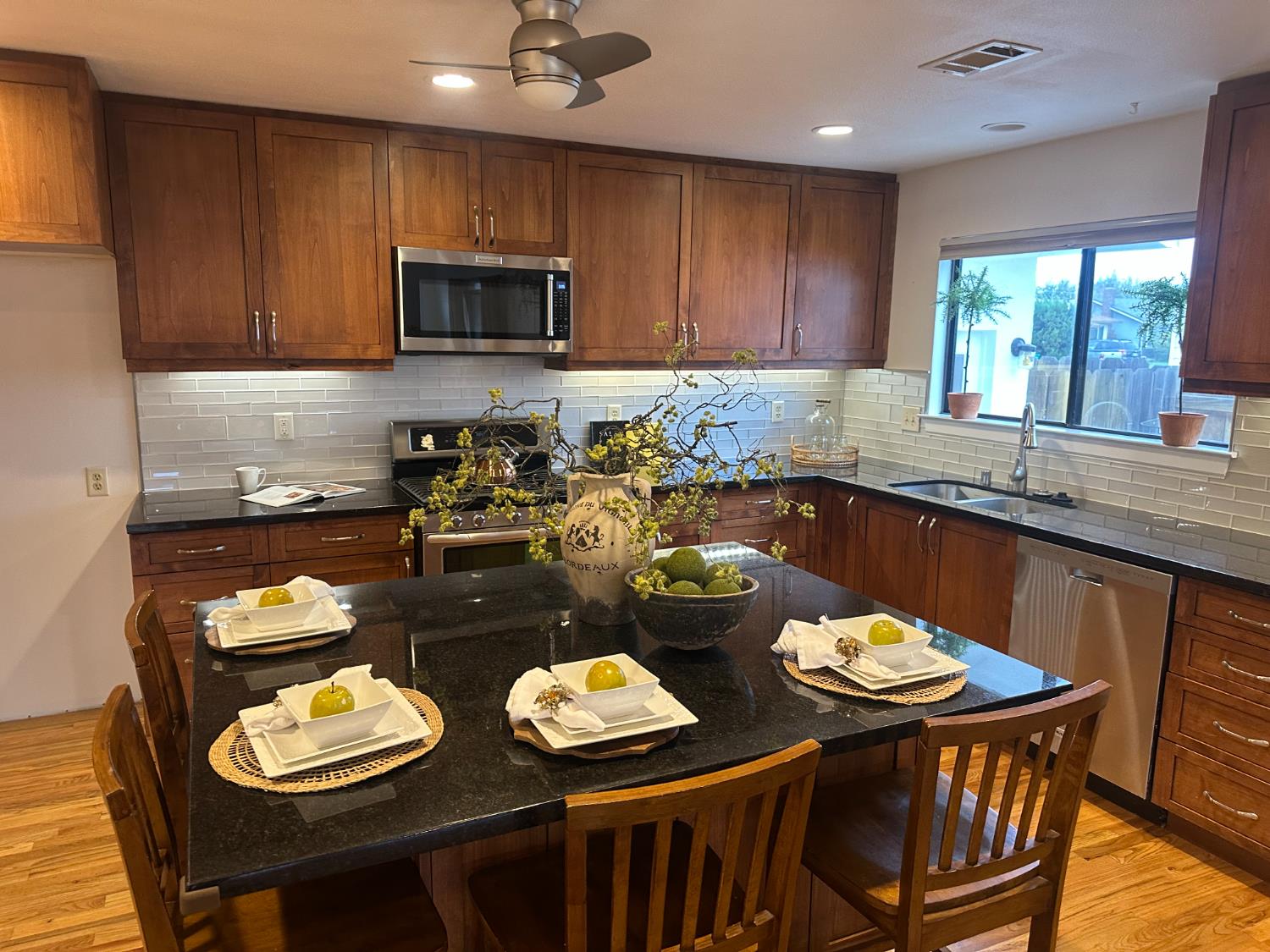2013 Jerry Lane Lodi, CA 95242 - Photo 17 of 52 a kitchen with stainless steel appliances kitchen island granite countertop a sink a window and chairs