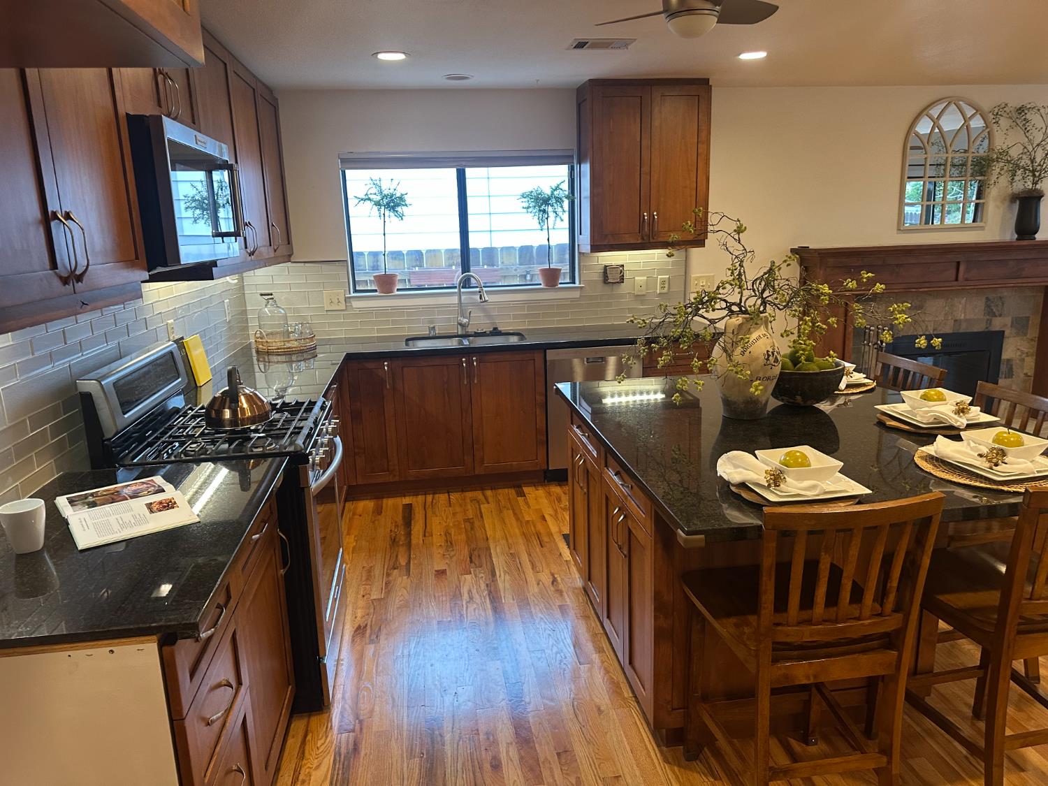 2013 Jerry Lane Lodi, CA 95242 - Photo 22 of 52 a kitchen with stainless steel appliances kitchen island granite countertop a stove a sink a dining table and chairs