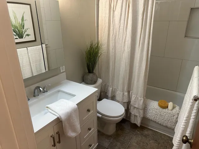 a bathroom with a sink a toilet and a mirror