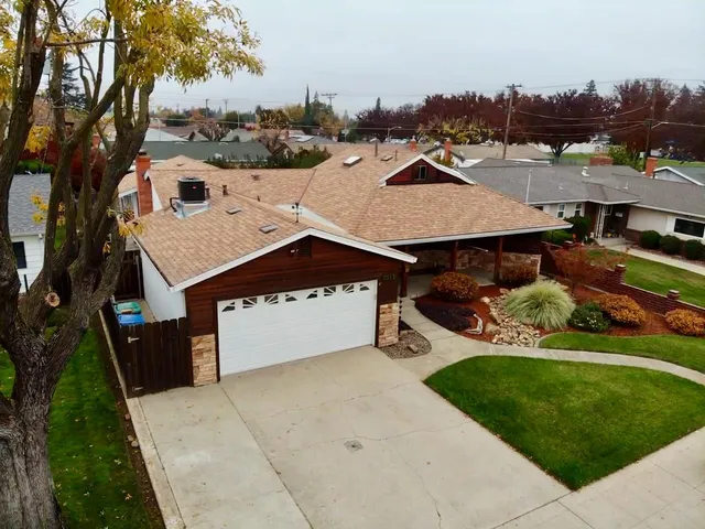 an aerial view of a house with a yard