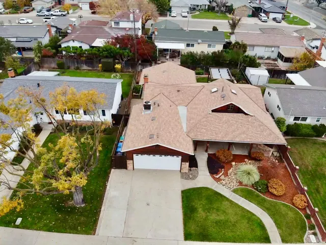 an aerial view of a house with yard swimming pool and outdoor seating