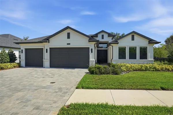 a front view of a house with a yard and garage