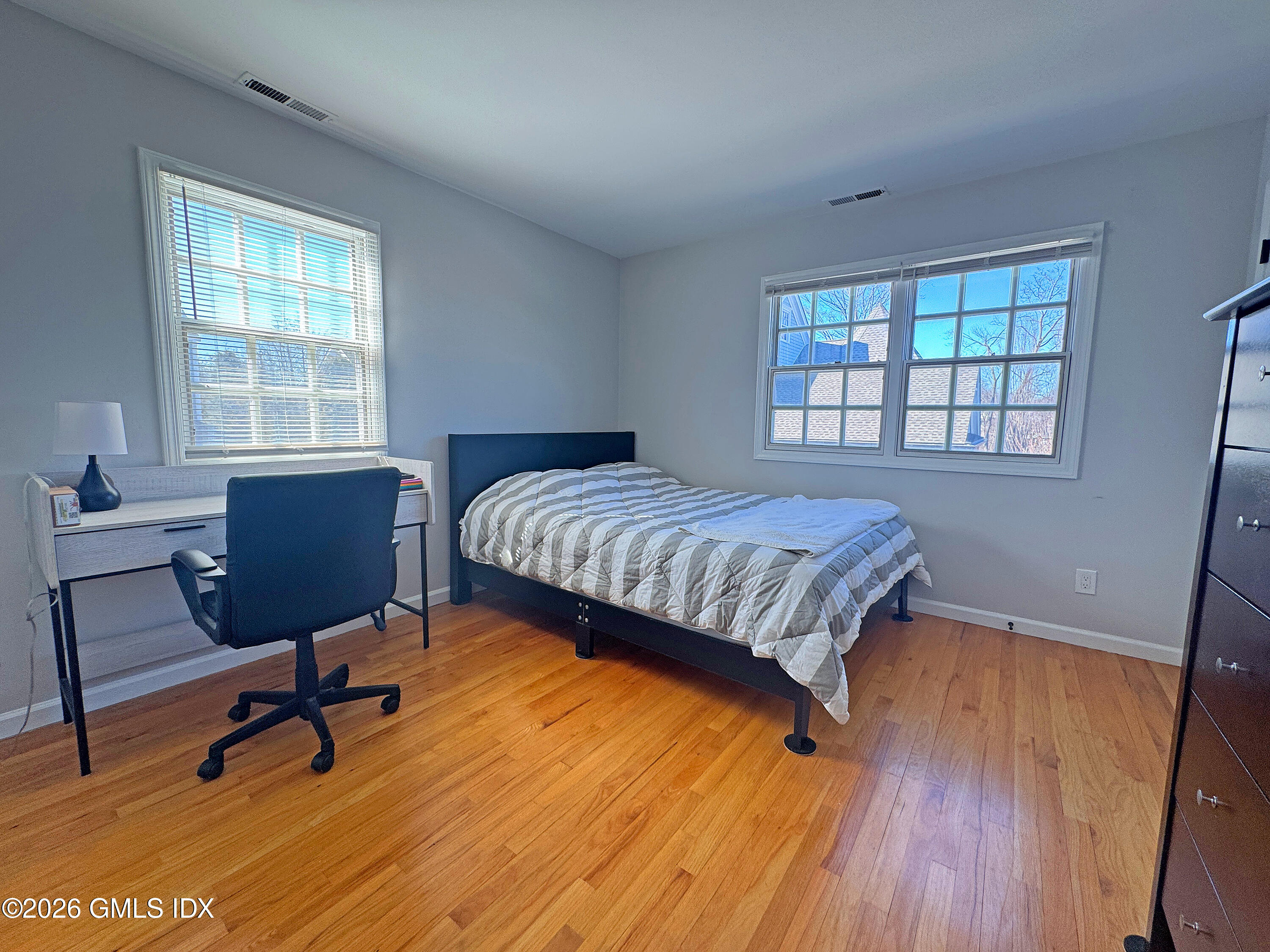 28 Home Place, Unit A2 Greenwich, CT 06830 - Photo 17 of 28 a bedroom with a bed and a chair