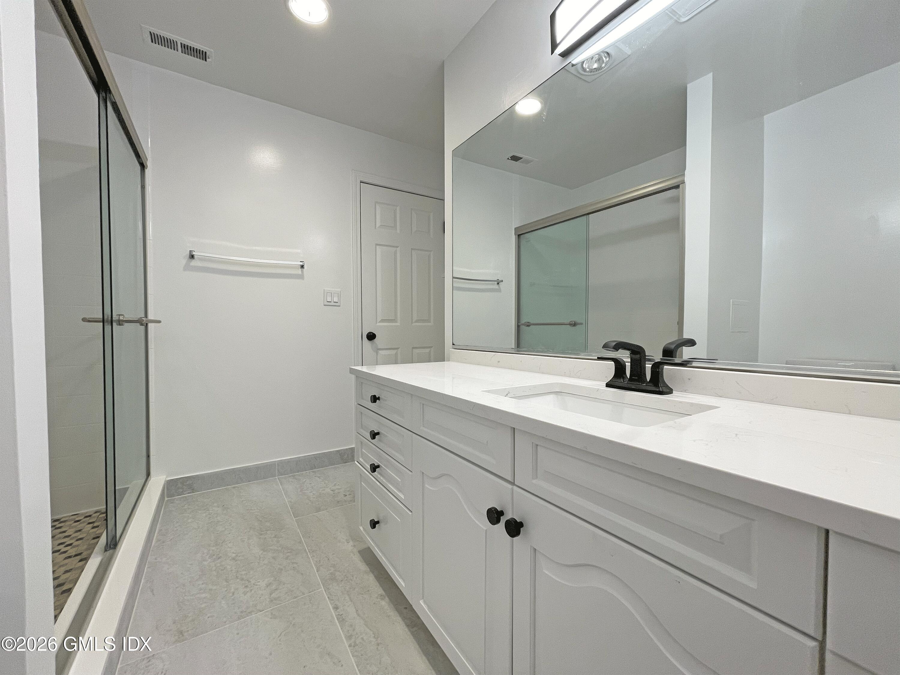 28 Home Place, Unit A2 Greenwich, CT 06830 - Photo 21 of 28 a bathroom with a sink and a mirror