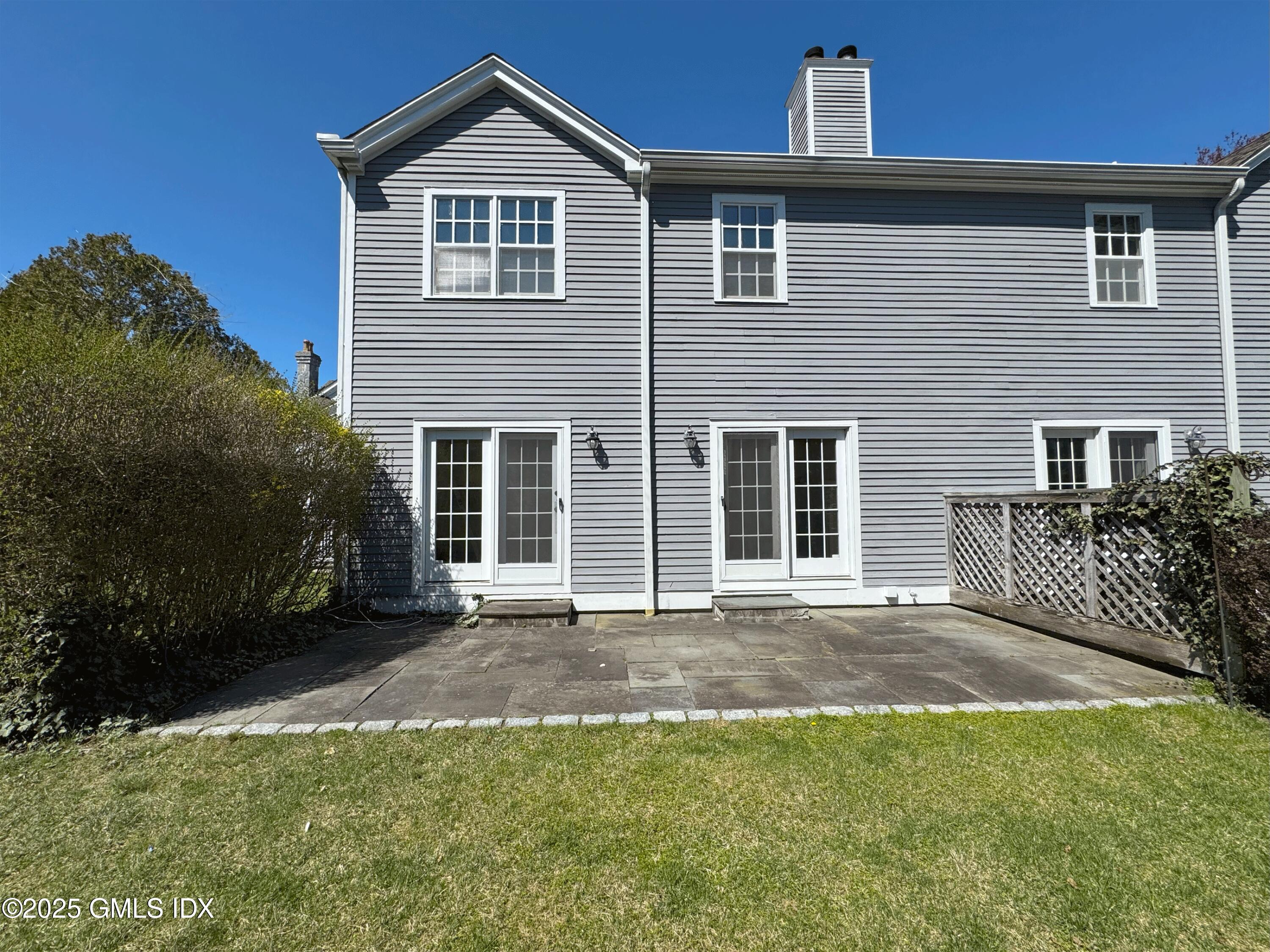 28 Home Place, Unit A2 Greenwich, CT 06830 - Photo 24 of 28 a front view of a house with a yard and garage