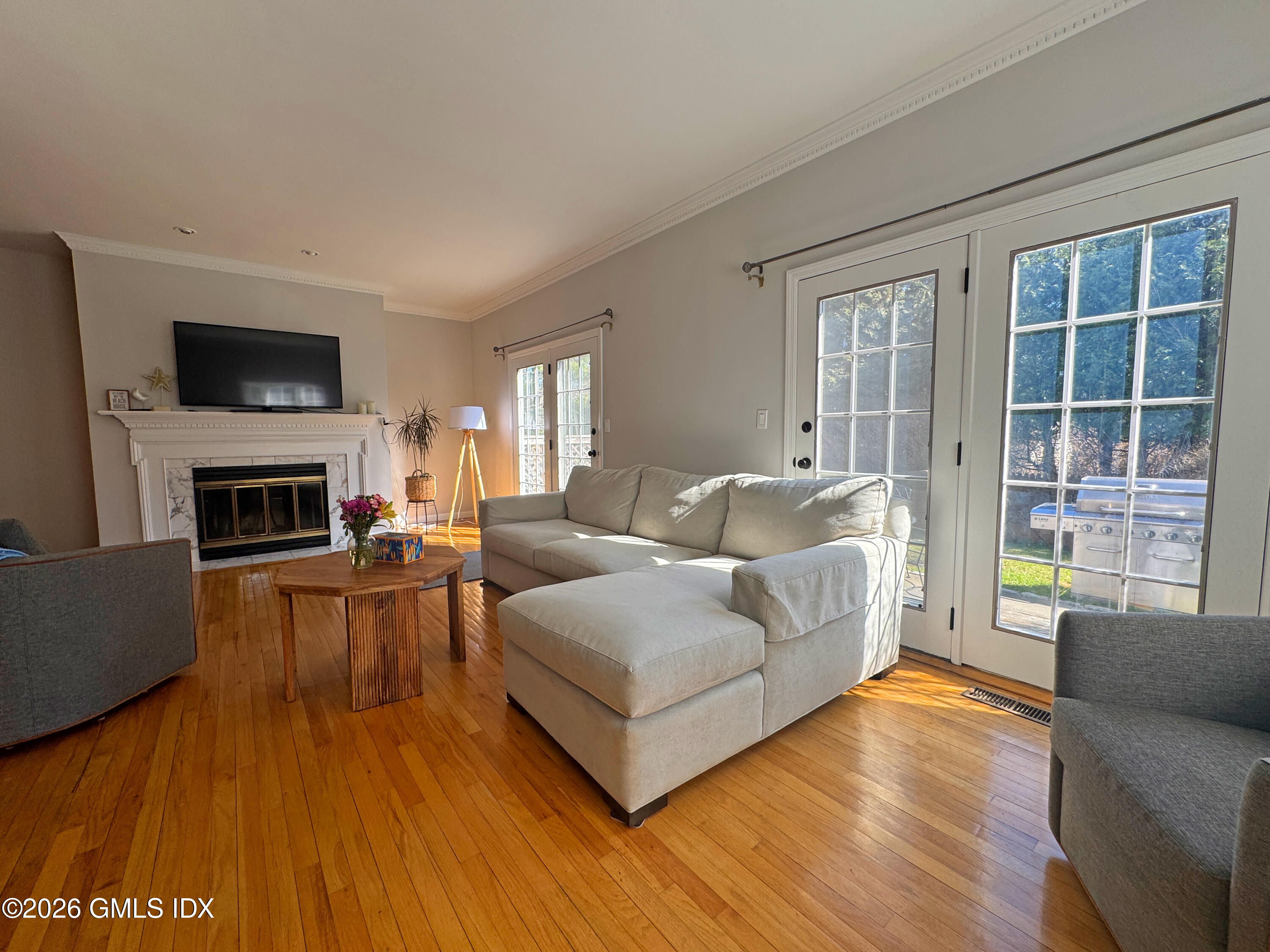 28 Home Place, Unit A2 Greenwich, CT 06830 - Photo 3 of 28 a living room with furniture a flat screen tv and a fireplace