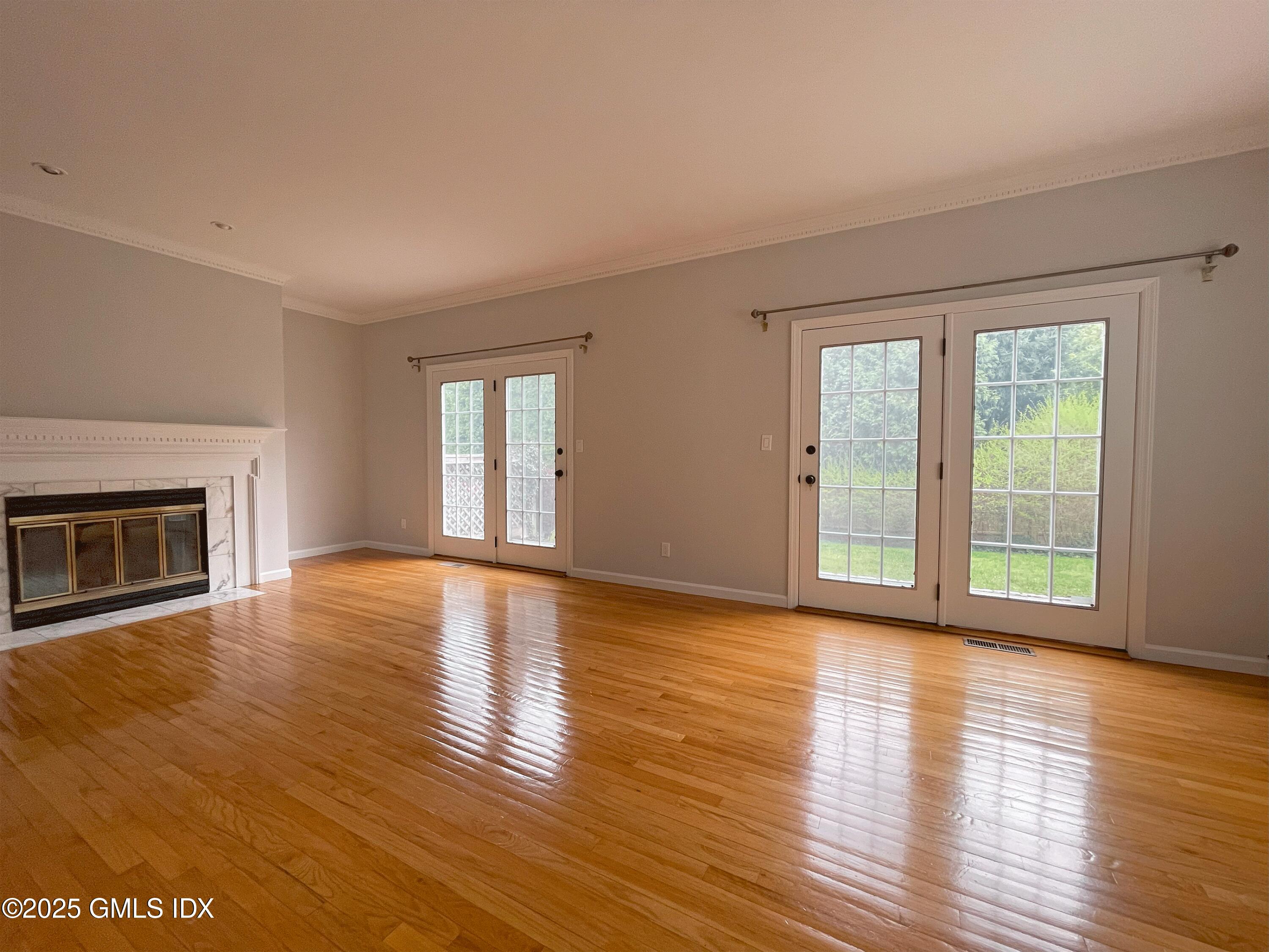 28 Home Place, Unit A2 Greenwich, CT 06830 - Photo 5 of 28 a view of an empty room with glass door and wooden floor