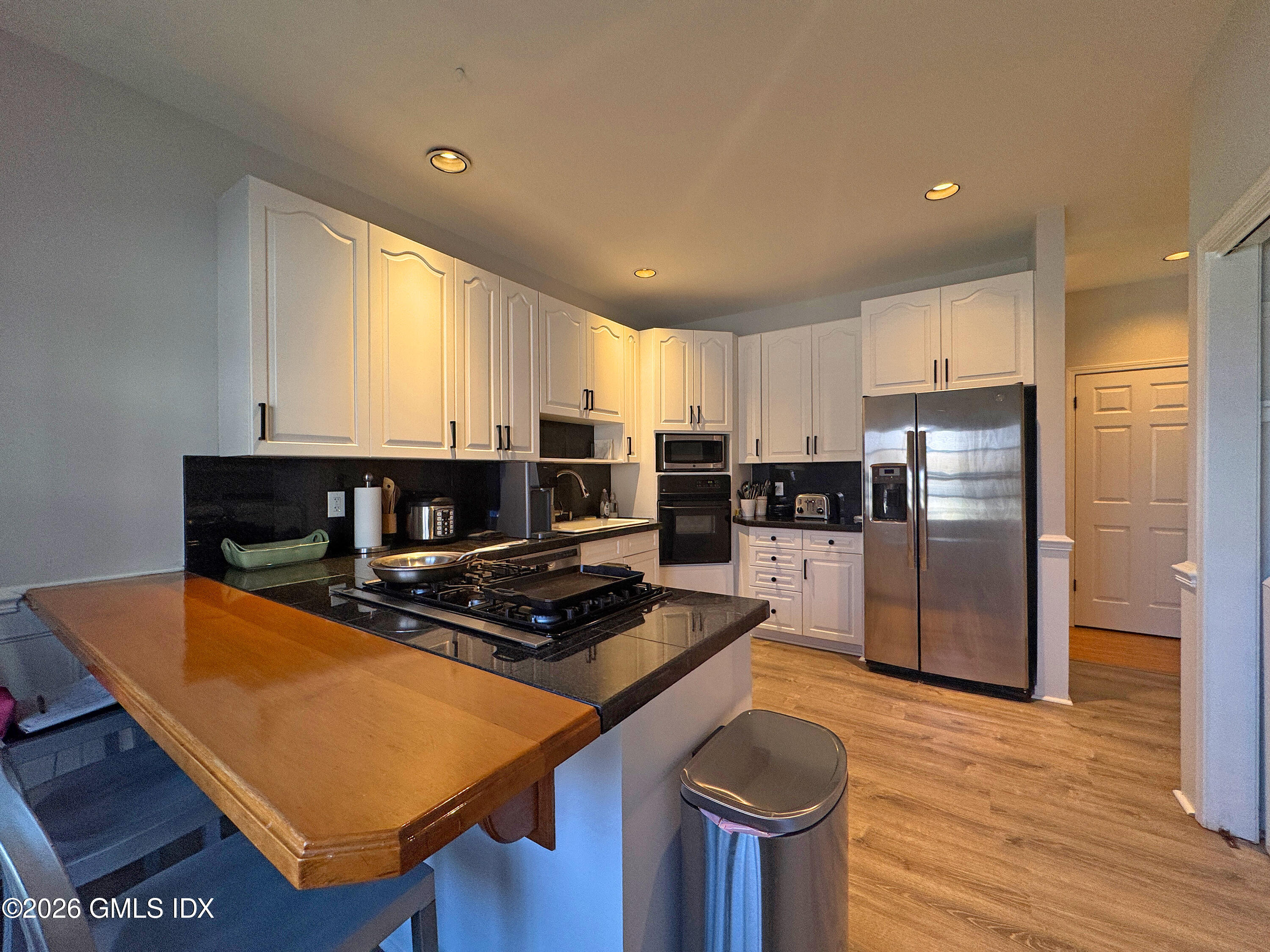 28 Home Place, Unit A2 Greenwich, CT 06830 - Photo 10 of 28 a kitchen with stainless steel appliances granite countertop a sink stove and refrigerator