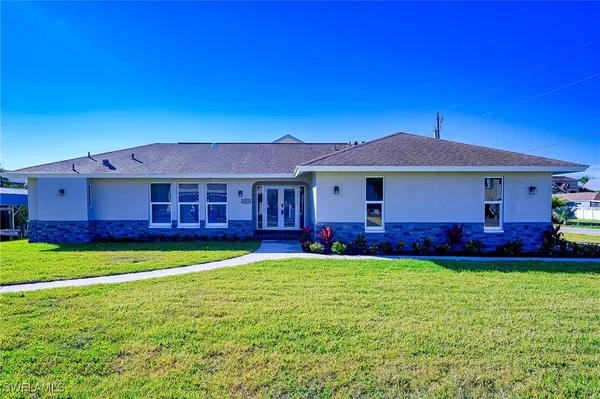 a view of a house with a yard and swimming pool