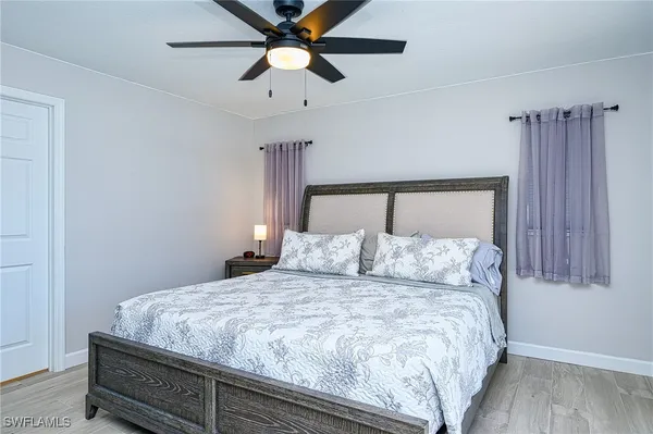 a bedroom with a large bed and a chandelier
