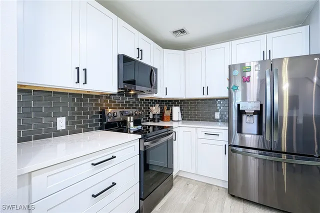 a kitchen with a refrigerator stove and microwave