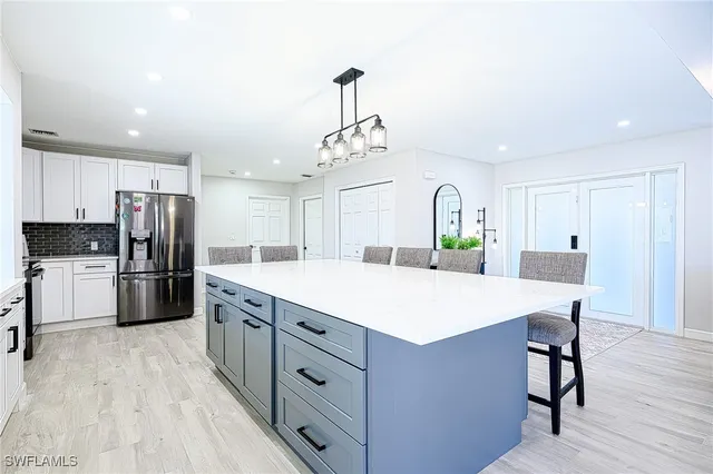 a kitchen with stainless steel appliances a refrigerator sink and cabinets