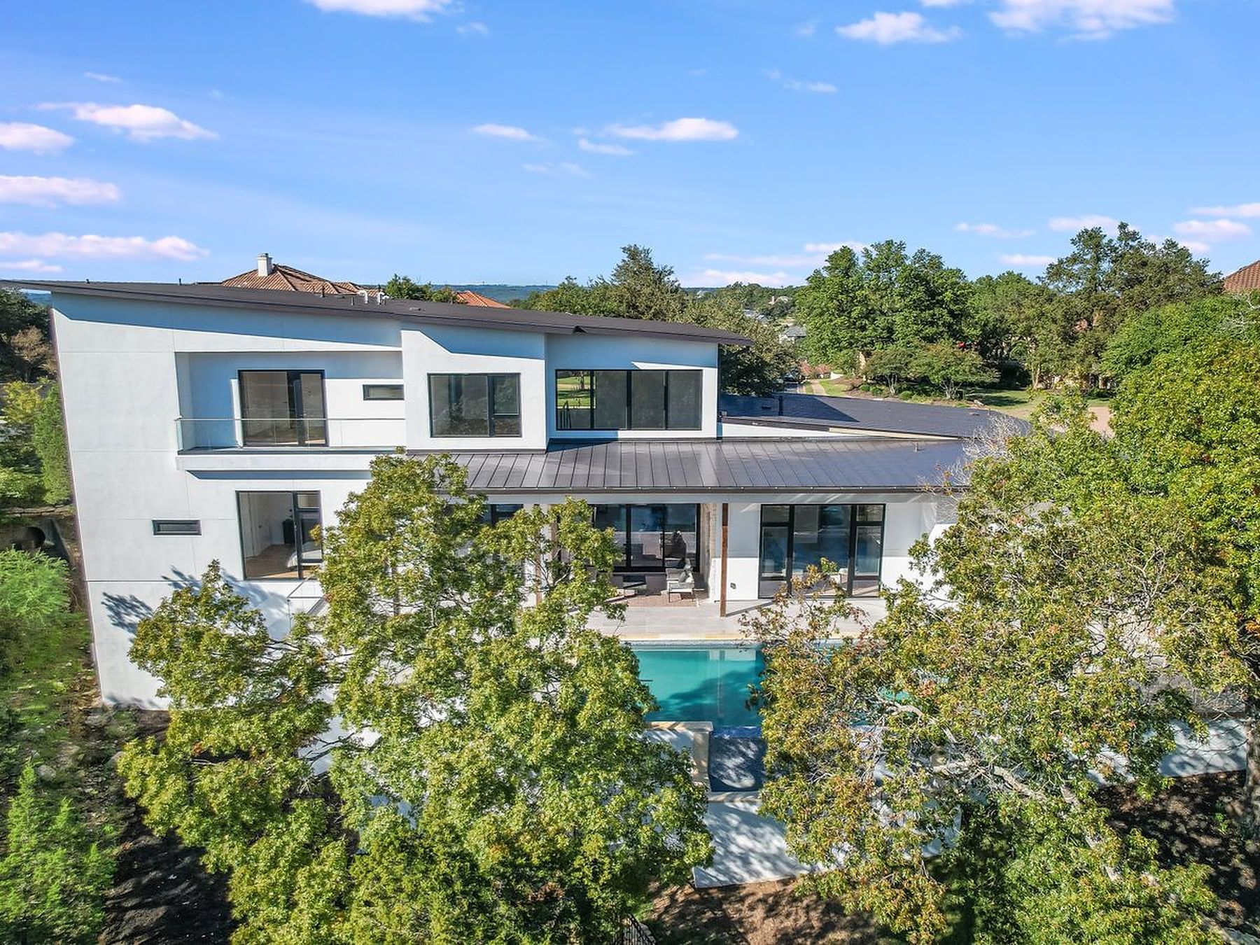 2476 Waymaker Way Austin, TX 78746 - Photo 27 of 31 A striking modern residence boasts multiple levels, an integrated pool, and generous outdoor spaces.