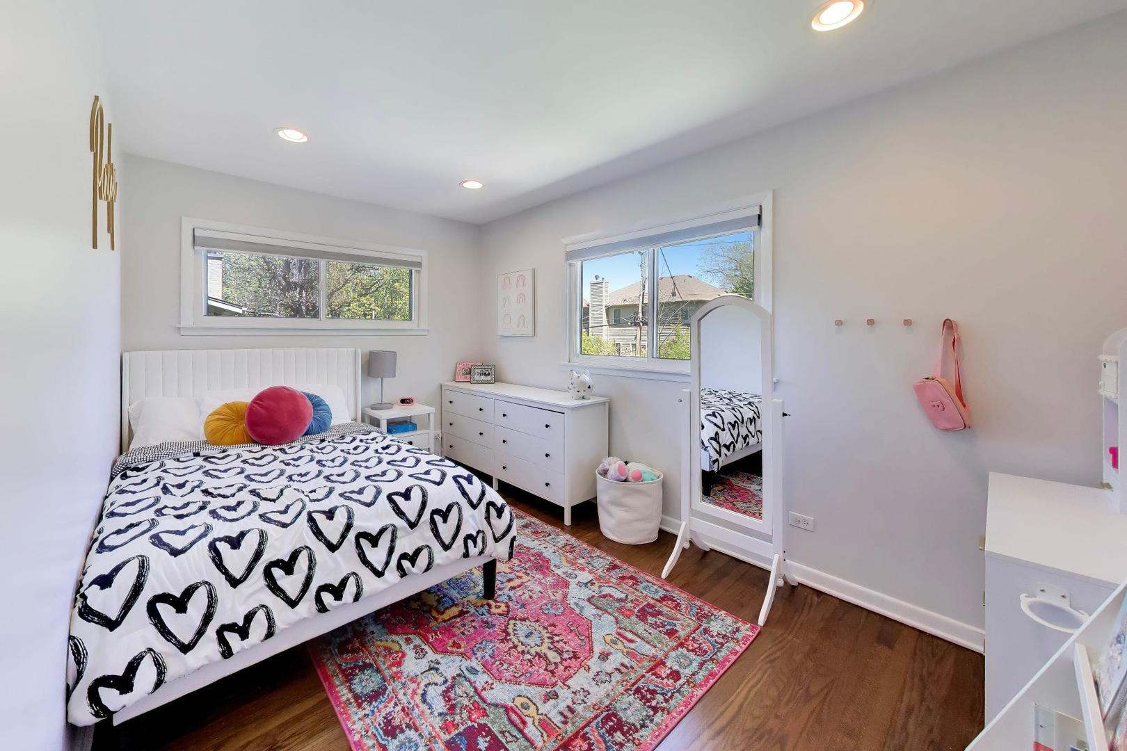 1153 Kenton Road Deerfield, IL 60015 - Photo 17 of 40 a bedroom with a bed and wooden floor
