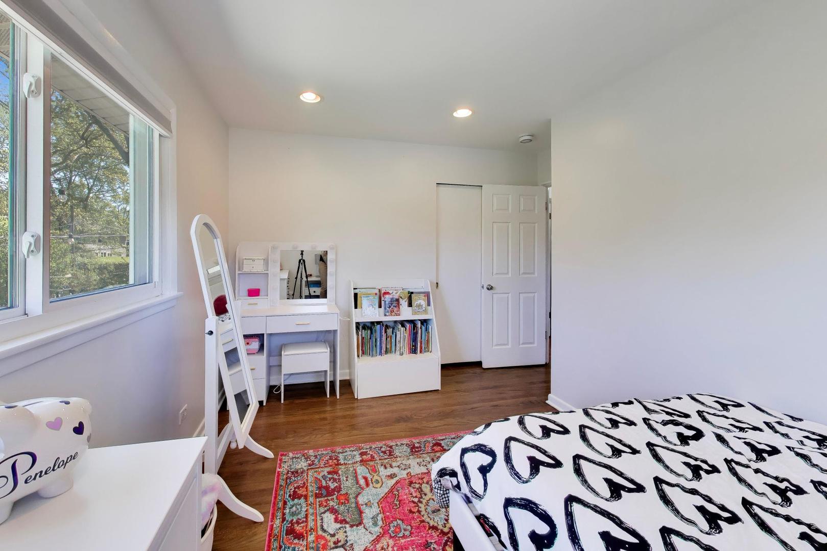 1153 Kenton Road Deerfield, IL 60015 - Photo 18 of 40 a bedroom with a bed and wooden floor