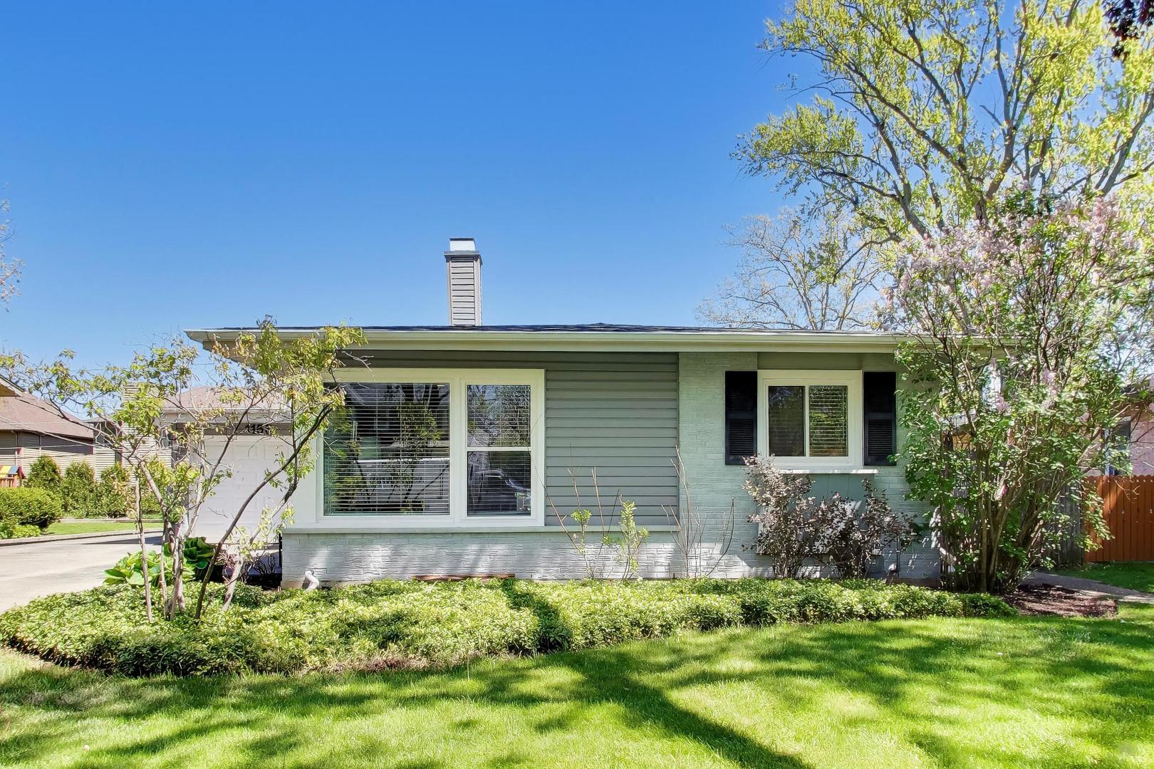 1153 Kenton Road Deerfield, IL 60015 - Photo 2 of 40 a front view of a house with a yard