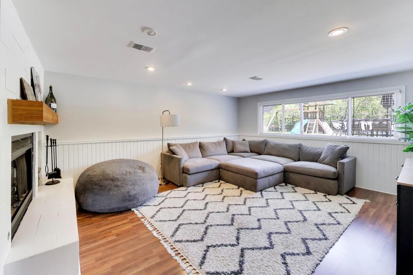 1153 Kenton Road Deerfield, IL 60015 - Photo 22 of 40 a living room with furniture and a fireplace