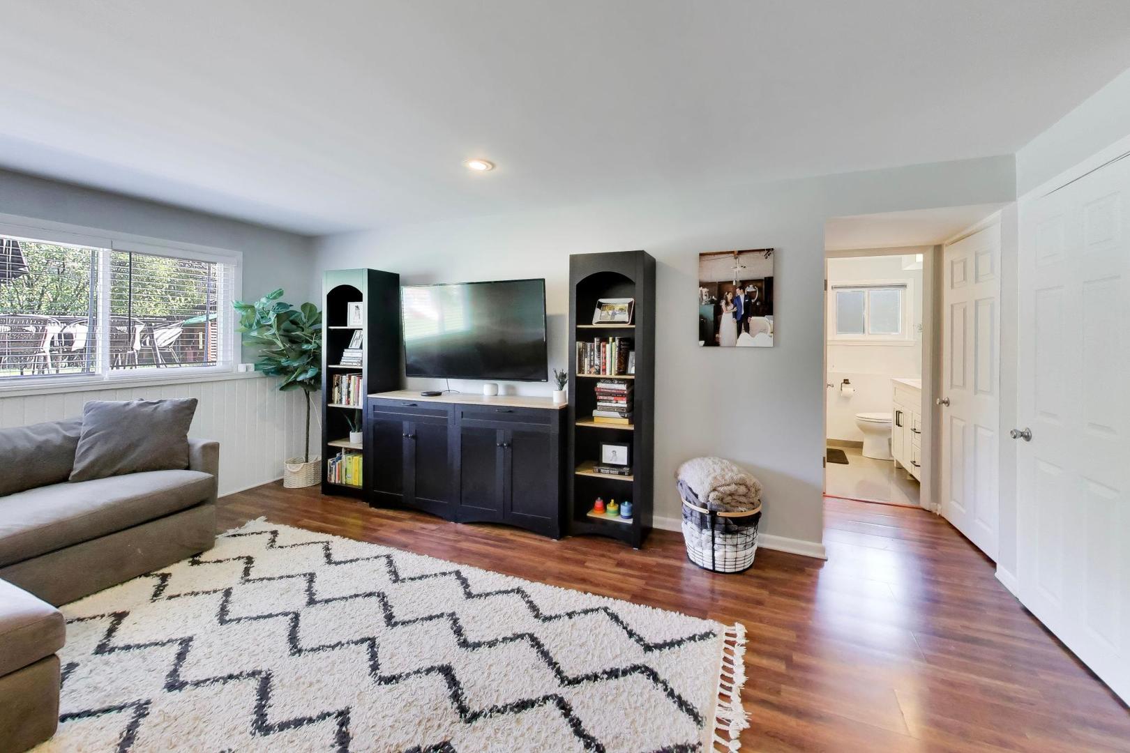 1153 Kenton Road Deerfield, IL 60015 - Photo 23 of 40 a living room with furniture and a flat screen tv