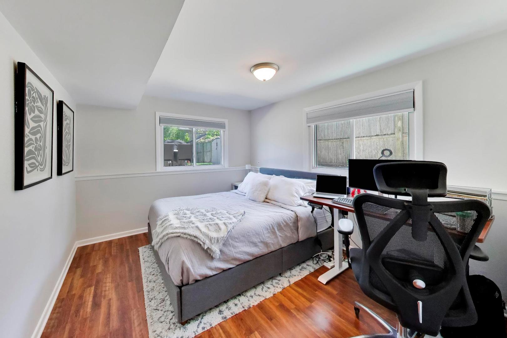1153 Kenton Road Deerfield, IL 60015 - Photo 25 of 40 a bedroom with a bed and wooden floor
