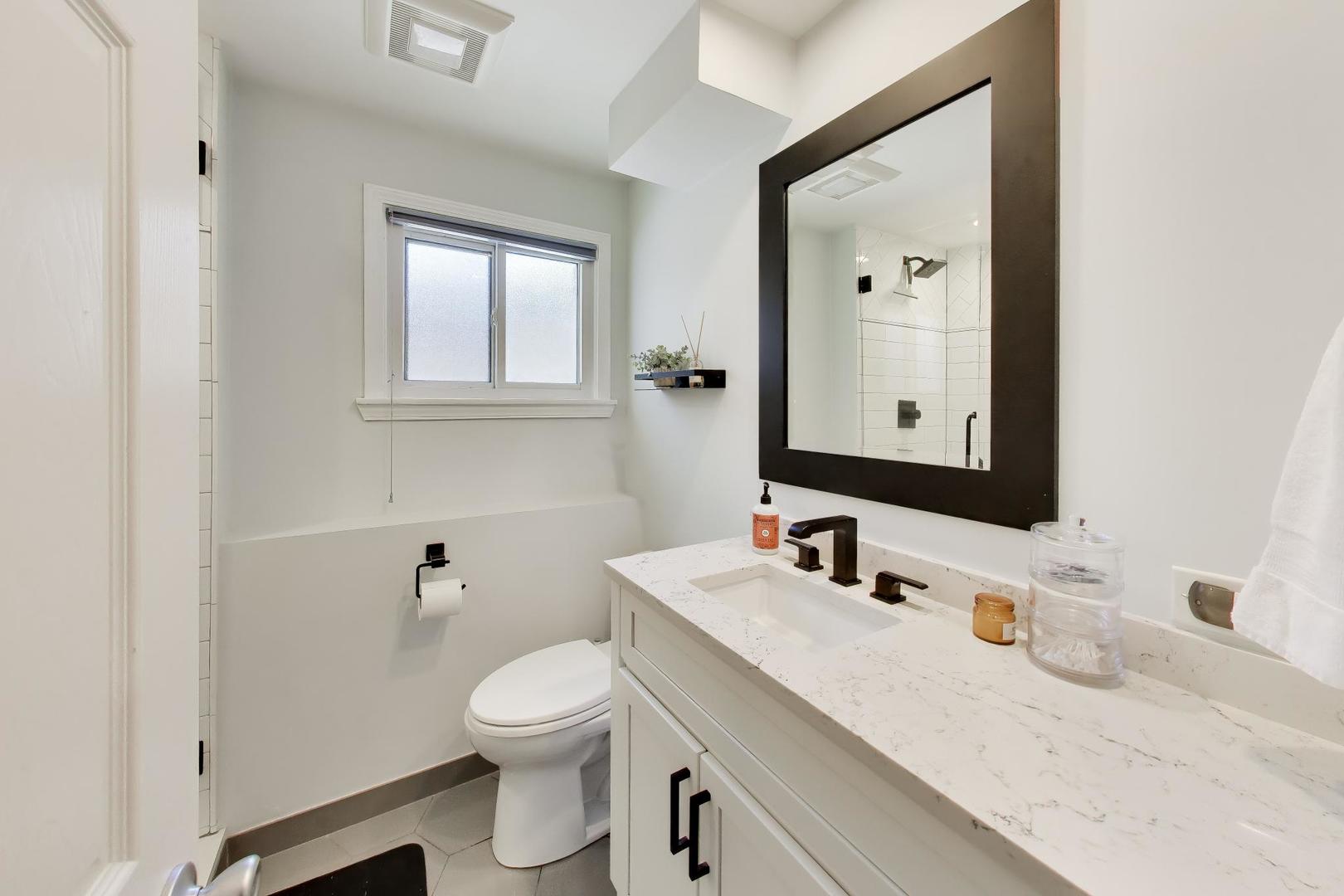 1153 Kenton Road Deerfield, IL 60015 - Photo 27 of 40 a bathroom with a granite countertop toilet sink and a mirror