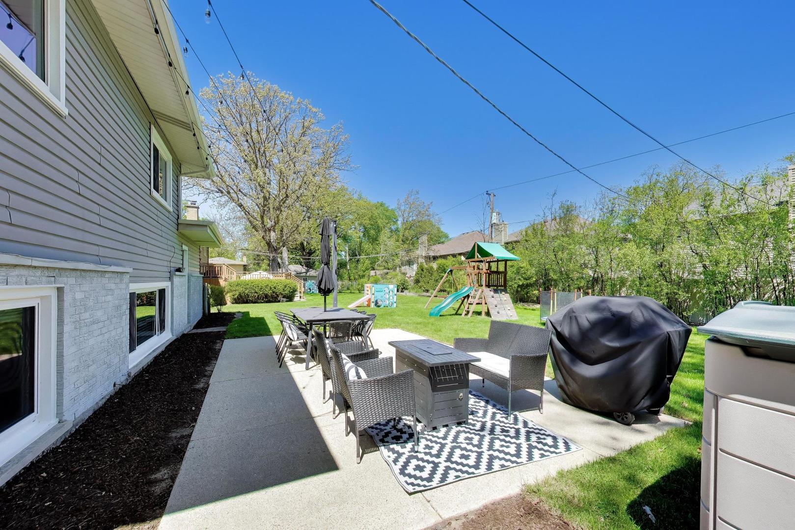 1153 Kenton Road Deerfield, IL 60015 - Photo 34 of 40 a view of a patio with table and chairs and potted plants