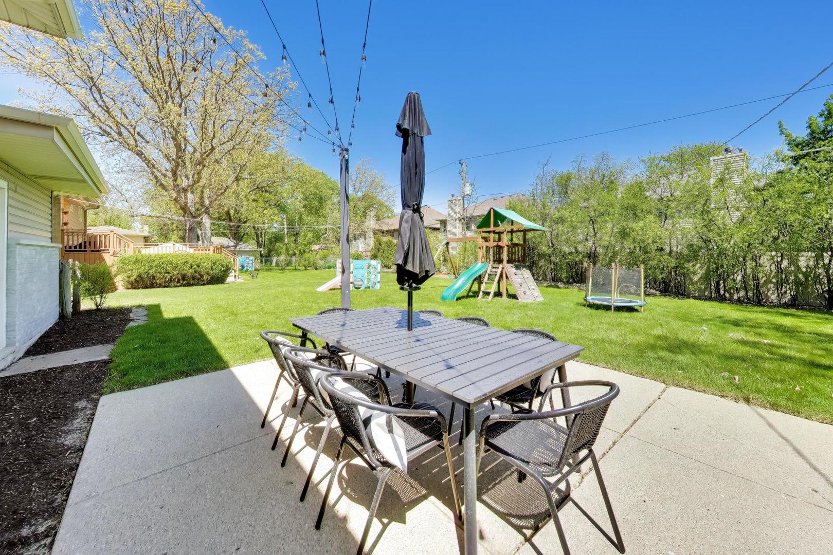 1153 Kenton Road Deerfield, IL 60015 - Photo 35 of 40 a table and chairs with the view of back yard