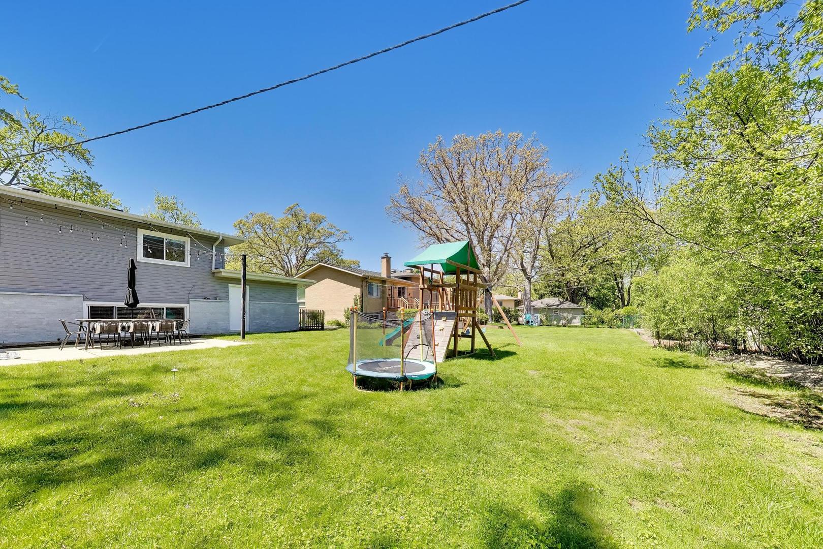 1153 Kenton Road Deerfield, IL 60015 - Photo 37 of 40 a view of a house with a yard and sitting area