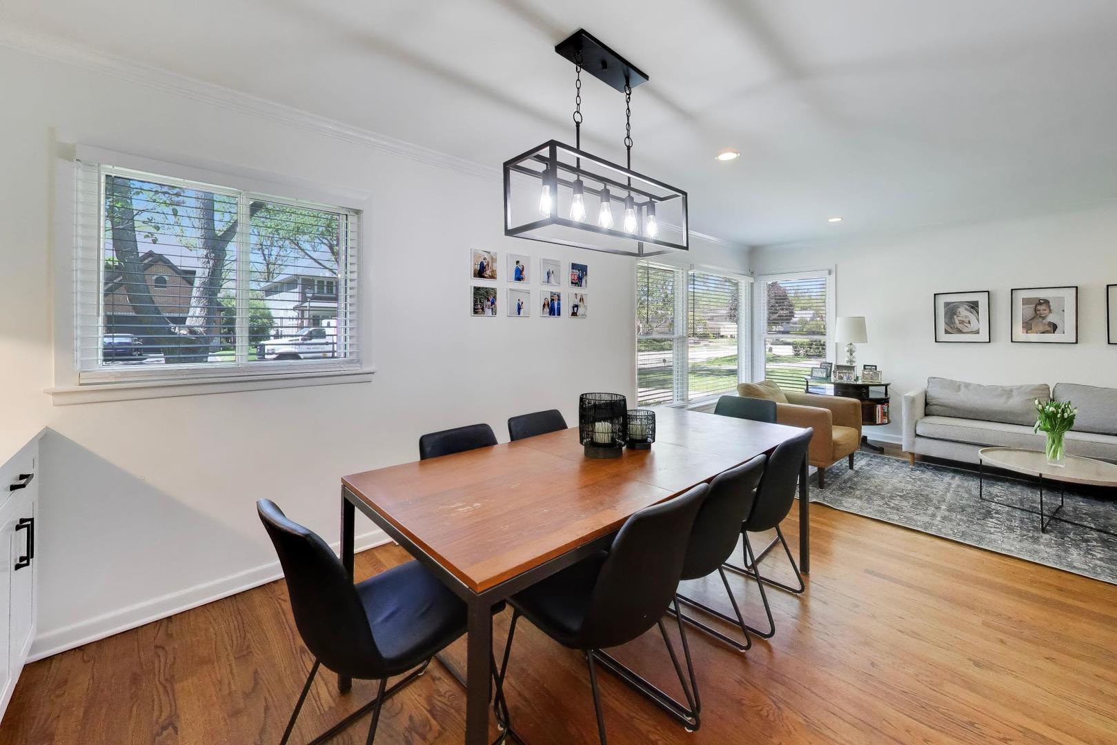 1153 Kenton Road Deerfield, IL 60015 - Photo 10 of 40 a view of a dining room with furniture wooden floor and a chandelier