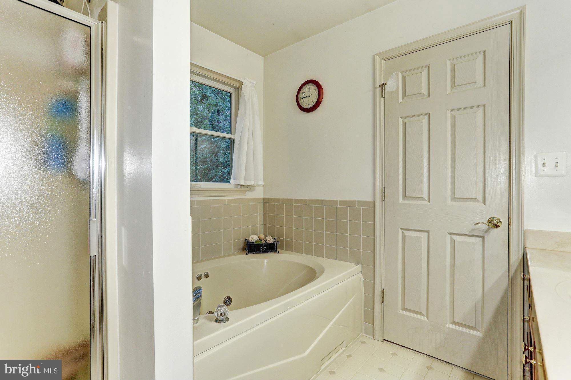 4006 Roop Road New Windsor, MD 21776 - Photo 12 of 22 a bathroom with a tub a sink and a window