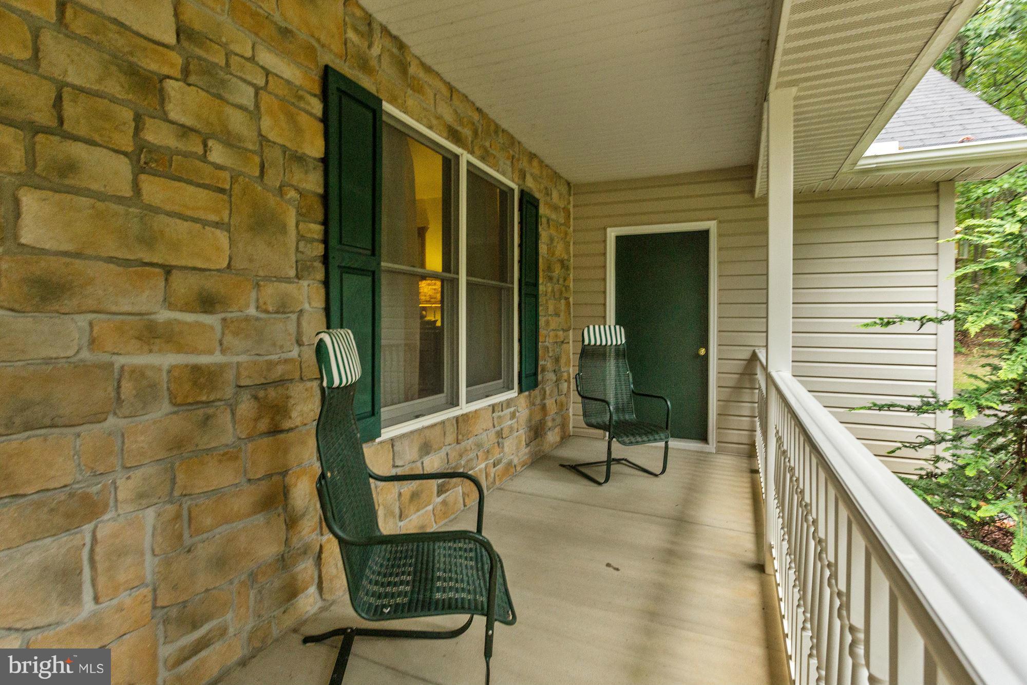 4006 Roop Road New Windsor, MD 21776 - Photo 21 of 22 a view of a balcony with chairs and a potted plant
