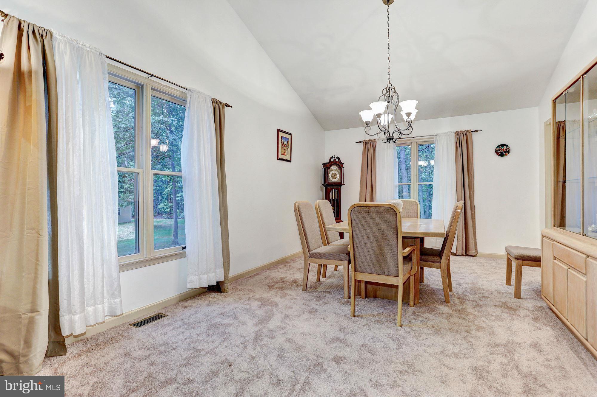 4006 Roop Road New Windsor, MD 21776 - Photo 5 of 22 a dining room with furniture a chandelier and a rug
