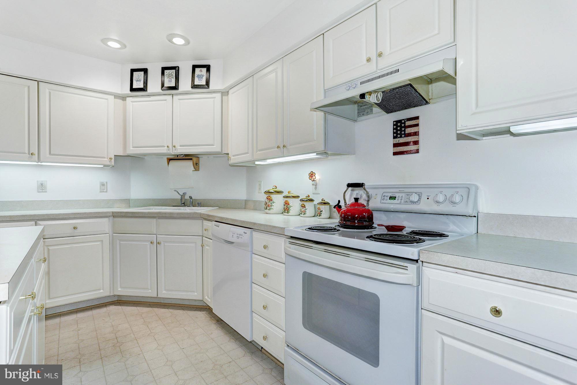 4006 Roop Road New Windsor, MD 21776 - Photo 6 of 22 a kitchen with white cabinets and white appliances