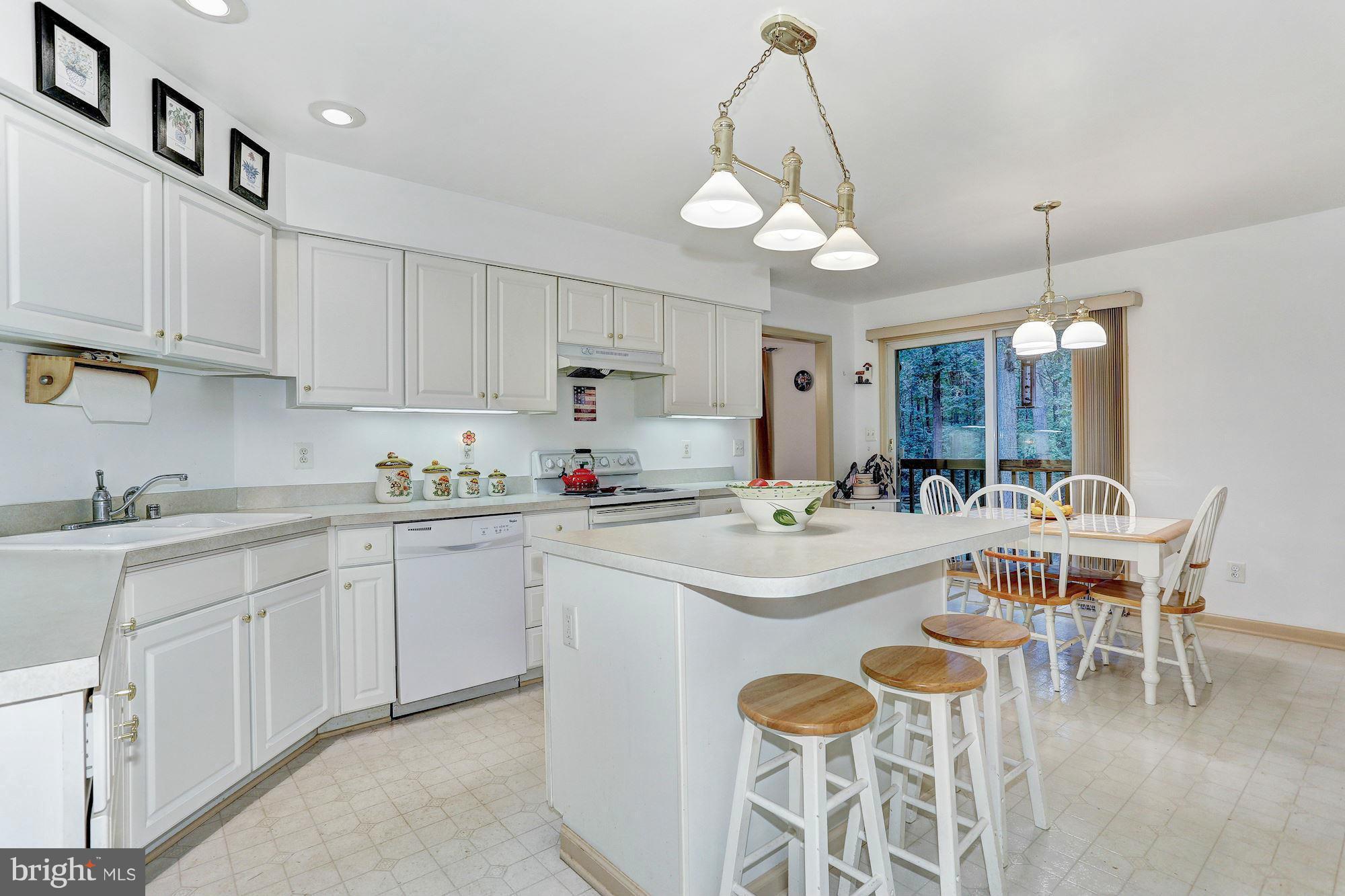 4006 Roop Road New Windsor, MD 21776 - Photo 7 of 22 a kitchen with a sink and chairs