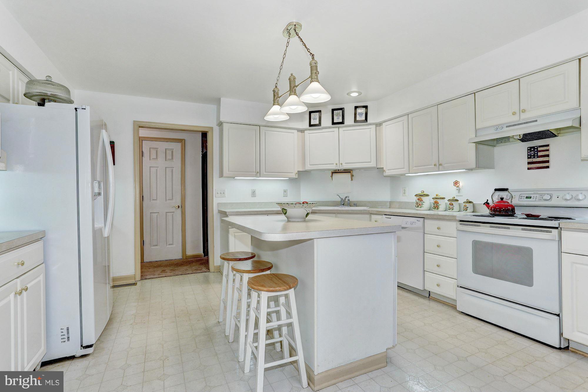 4006 Roop Road New Windsor, MD 21776 - Photo 8 of 22 a kitchen with stainless steel appliances granite countertop a sink a stove a refrigerator and cabinets
