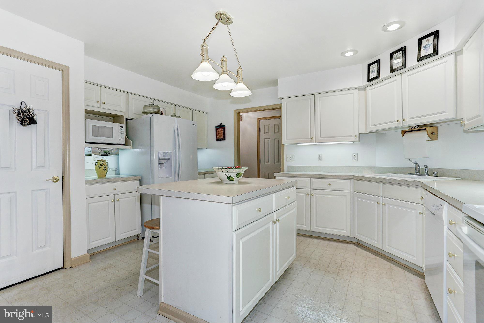 4006 Roop Road New Windsor, MD 21776 - Photo 9 of 22 a kitchen that has a lot of white cabinets and stainless steel appliances