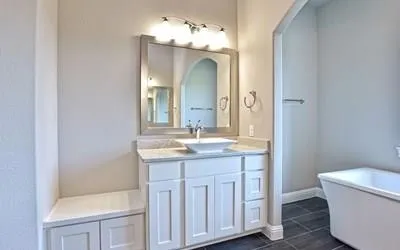a bathroom with a granite countertop sink a toilet and a mirror