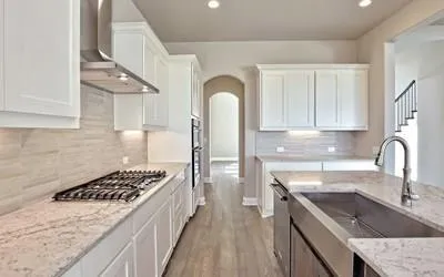 a kitchen with a stove a sink and a refrigerator