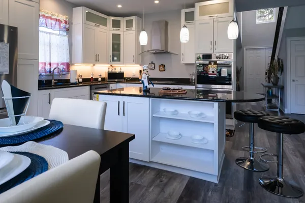 a bathroom with a tub sink and mirror