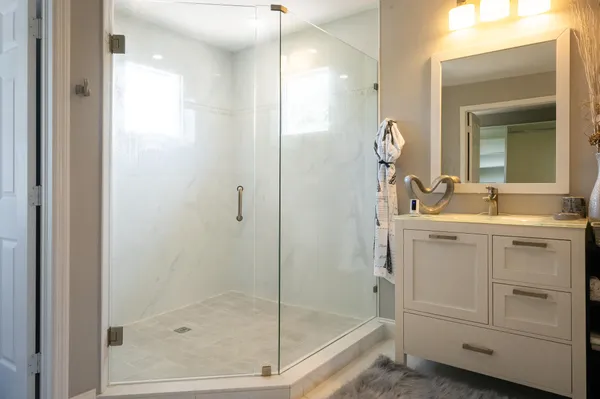 a kitchen with granite countertop white cabinets and white appliances
