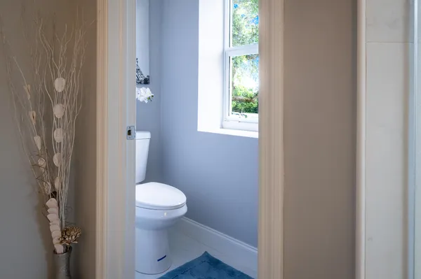 a bedroom with a bed and painting on the wall