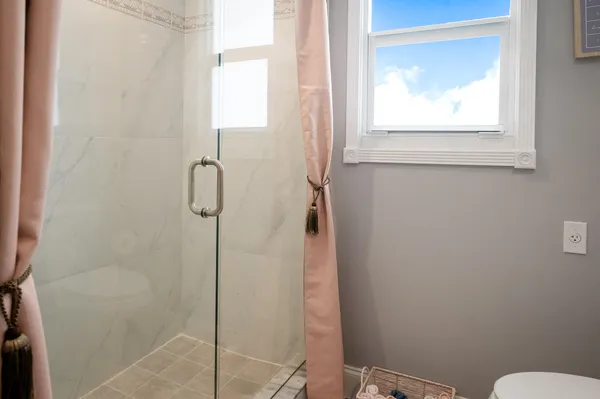 a spacious bedroom with a bed and a flat screen tv