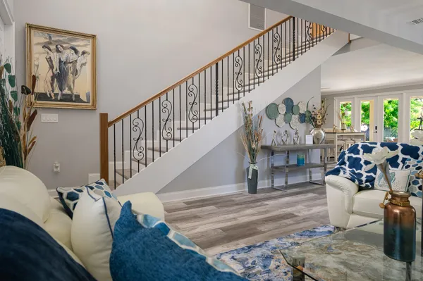 a living room with furniture flowerpot and window