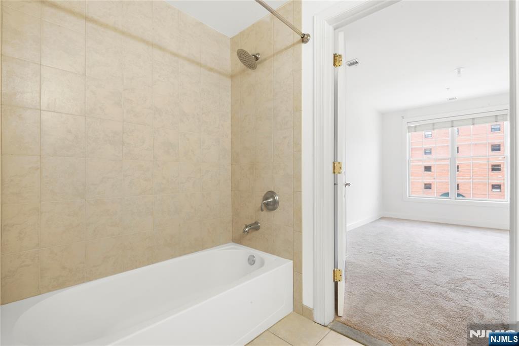 54 Polifly Road, Unit 311 Hackensack, NJ 07601 - Photo 16 of 20 a bathroom with a bathtub and shower