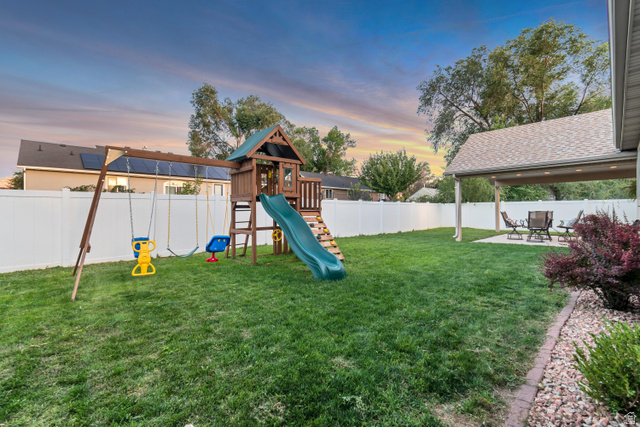 356 North 230 West Payson, UT 84651 - Photo 32 of 45 Expansive backyard featuring a covered patio, manicured lawn, and white privacy fencing