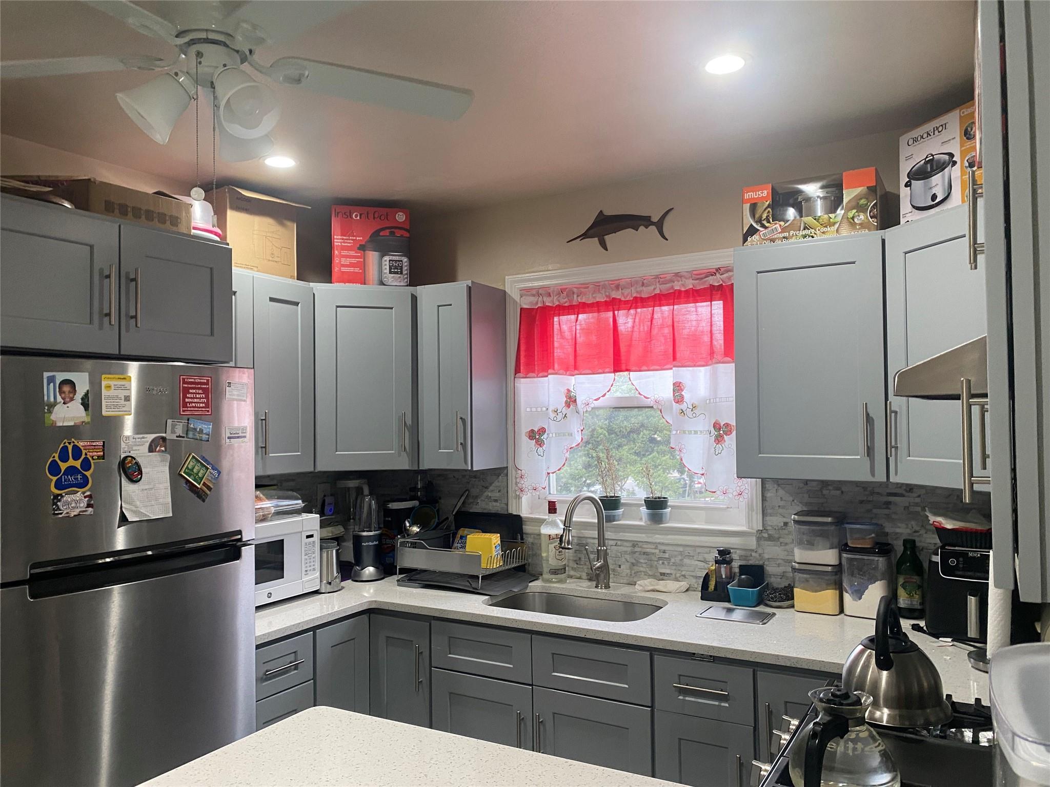 106-60 Ditmars Boulevard Queens, NY 11369 - Photo 11 of 12 a kitchen with refrigerator a sink and cabinets