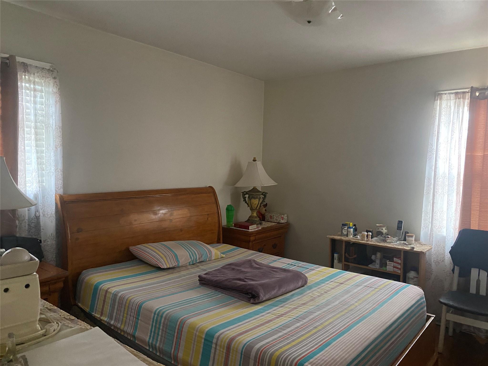 106-60 Ditmars Boulevard Queens, NY 11369 - Photo 2 of 12 a bedroom with a bed and a window