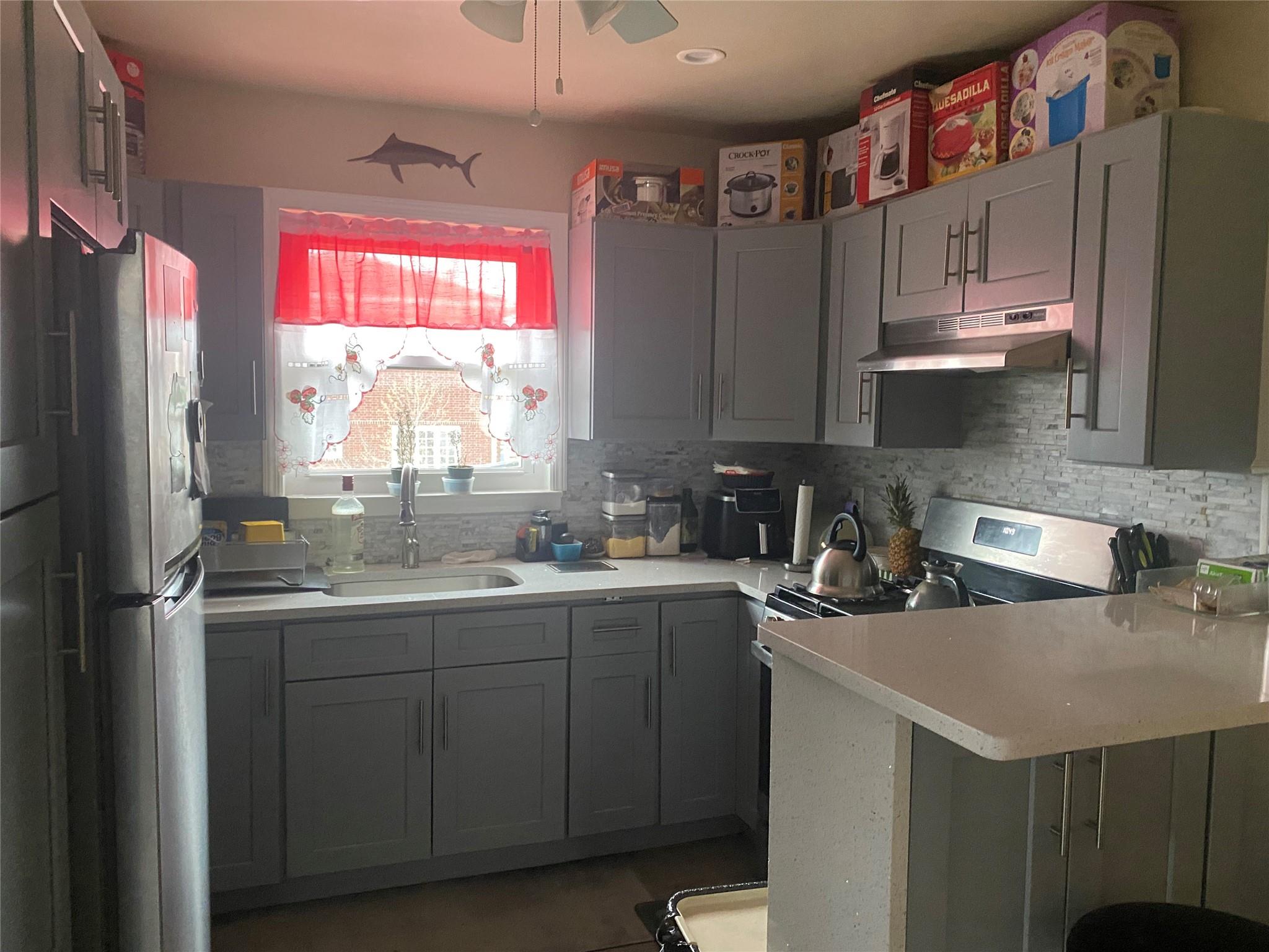 106-60 Ditmars Boulevard Queens, NY 11369 - Photo 3 of 12 a kitchen with a sink a window and stainless steel appliances